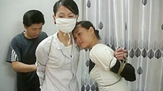 Two Chinese Girls Tied, One Wearing Cloth Mask