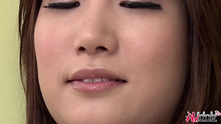 Thai woman Mikuni Maisaki likes to tease herself on the couch with a sex toy.